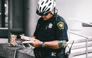 A security service officer checking cards outside a commercial building