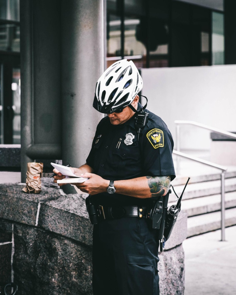 A security service officer checking cards outside a commercial building