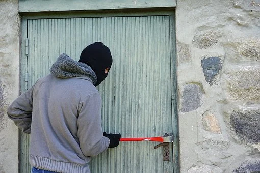 A thief trying to enter a storage unit