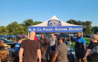 Armed security for crowd control in front of stalls at an event