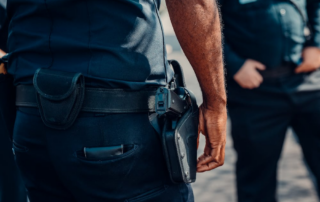 An image of a person with a gun strapped to their belt
