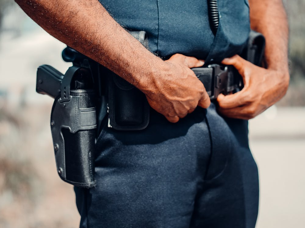 An image of a person with a gun strapped to their belt