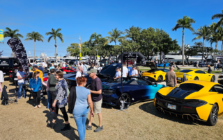 This photo shows people walking casually along a car exhibition.