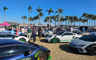 This photo shows cars surrounded by people