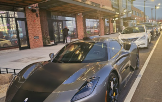 This photo shows a car and a guard at the building entrance.