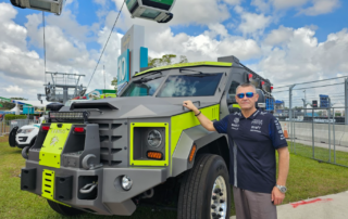 This photo shows a professional standing outside a truck.