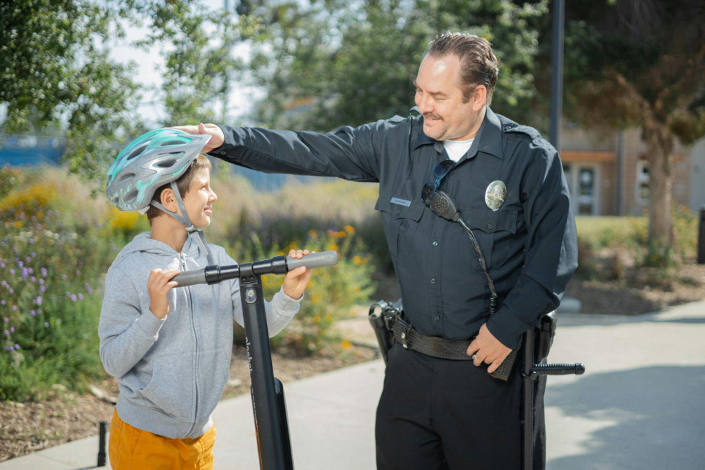 A child and security personnel conversing